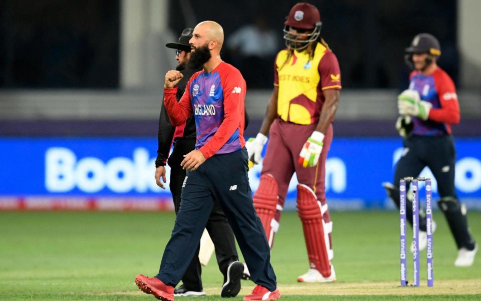 England's Moeen Ali (C) celebrates after taking the wicket of West Indies' Shimron Hetmyer (not pictured) during the ICC mens Twenty20 World Cup cricket match between England and West Indies at the Dubai International Cricket Stadium in Dubai on October 23, 2021.  - GETTY IMAGES