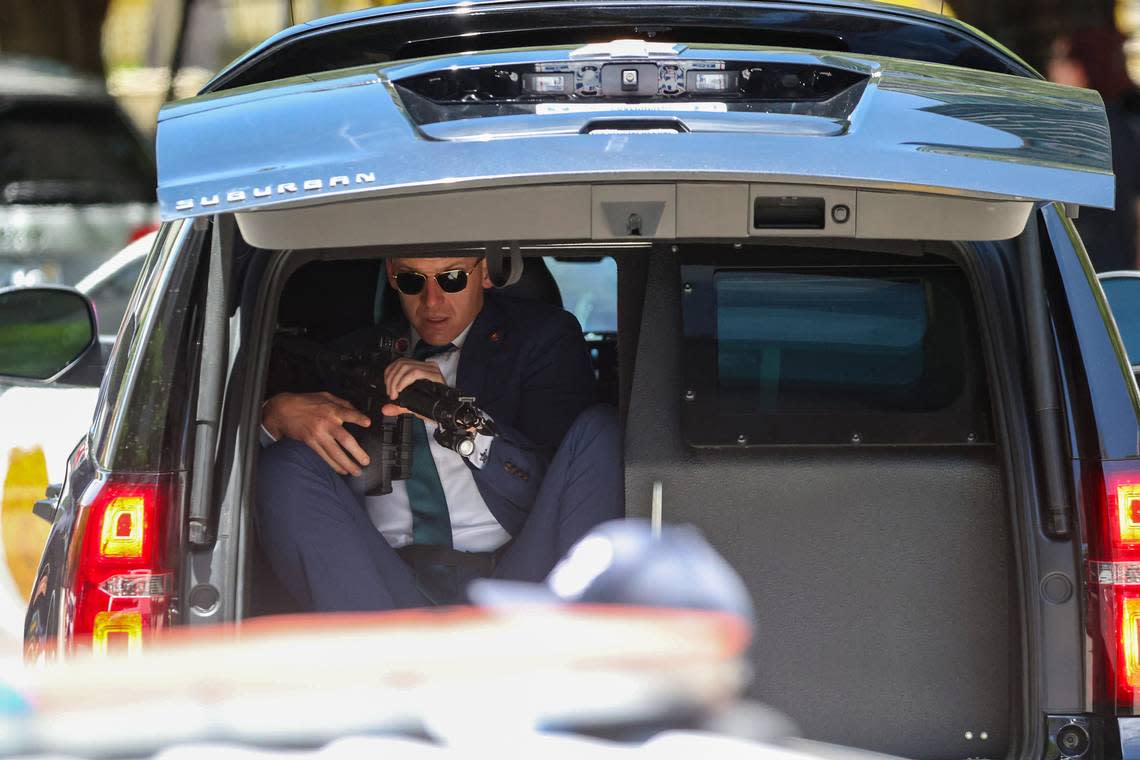 Former President Donald Trump’s motorcade arrived while a secret service agent holds a weapon at the Wilkie D. Ferguson Jr. U.S. Courthouse, Tuesday, June 13, 2023, in Miami.