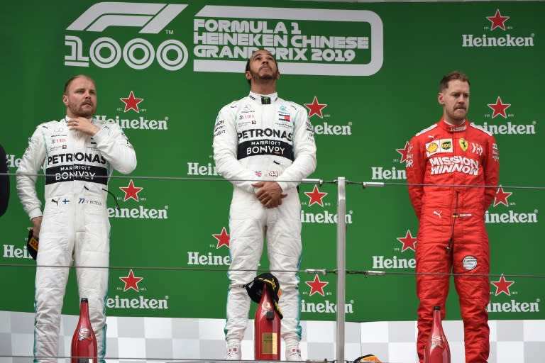 Lewis Hamilton and Valtteri Bottas were first and second for Mercedes at the last Chinese Grand Prix in 2019, with Sebastian Vettel third for Ferrari (STR)