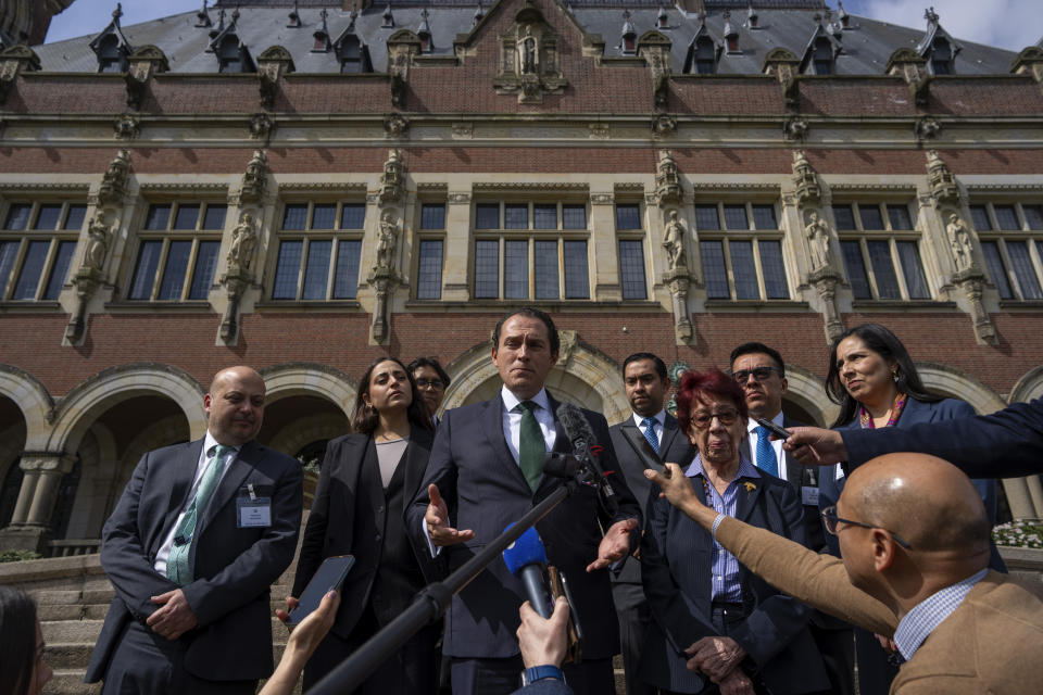 Mexico's legal advisor Alejandro Celorio Alcantar, center, and agent and ambassador Carmen Moreno Toscano, center right, and members of the delegation gave a brief statement outside the International Court of Justice in The Hague, Netherlands, Tuesday, April 30, 2024. Mexico is taking Ecuador to the top U.N. court Tuesday, accusing the nation of violating international law by storming the Mexican Embassy in Quito to arrest Jorge Glas, a former vice president who had just been granted asylum by Mexico. (AP Photo/Peter Dejong)