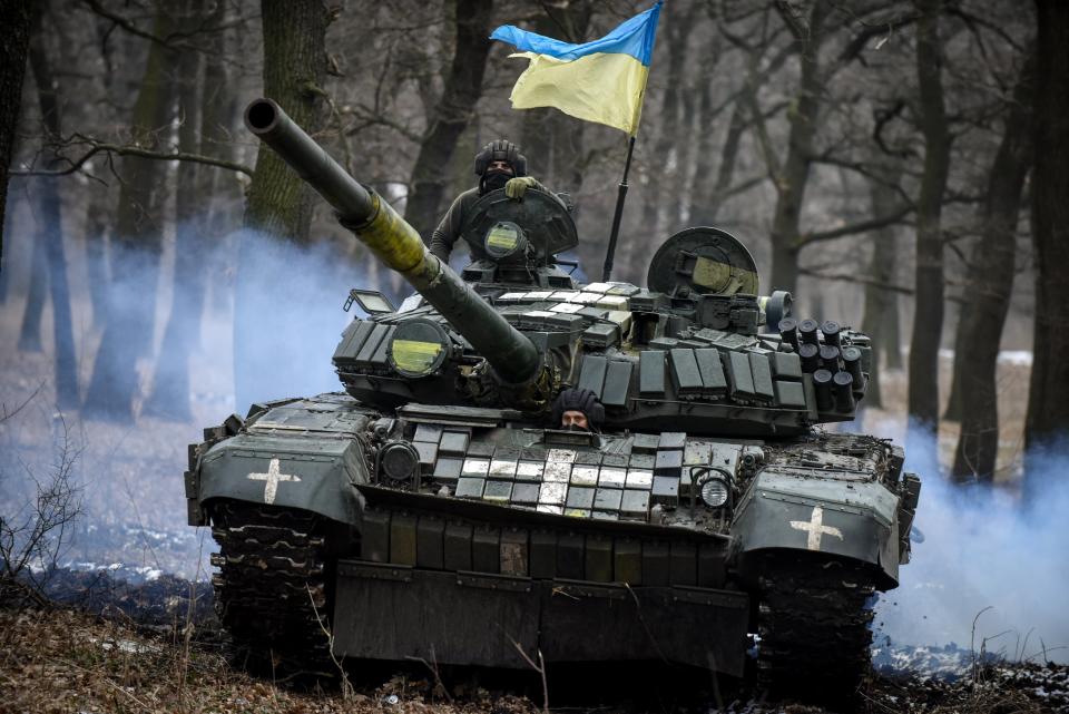 A Ukrainian T-72 tank manoeuvres through trees in Donetsk (EPA)