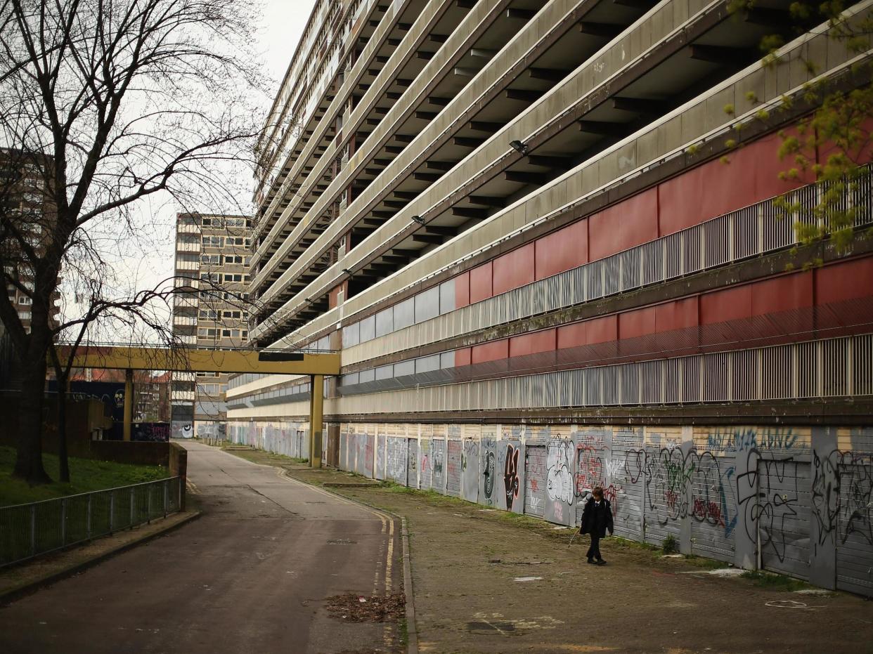 boy walks through the Heygate Estate in the Walworth area on April 24, 2013 in London, England. The Heygate estate in central London was built in 1974 as social housing and housed around 3000 people, but fell into a state of disrepair, gaining a reputation for crime and poverty: Getty