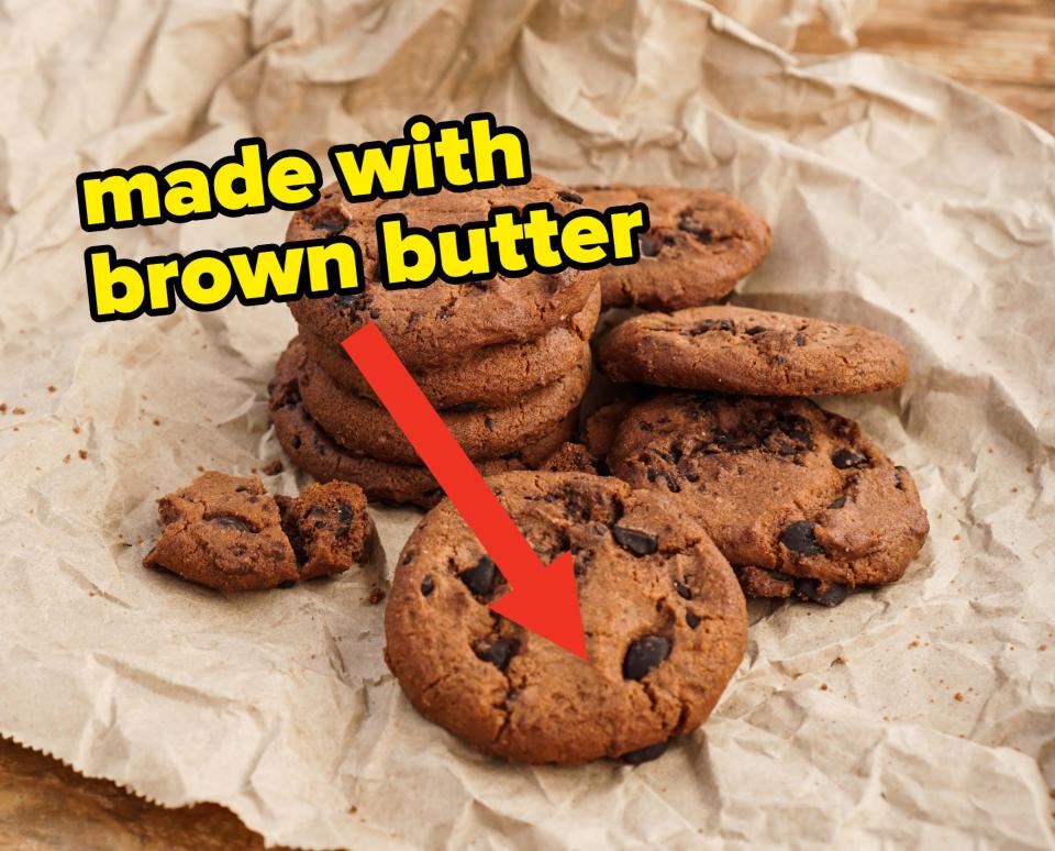 a pile of chocolate chip cookies with an arrow and words "made with brown butter"