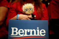 A supporter of U.S. Democratic presidential candidate Senator Sanders holds a Sanders doll during the first campaign rally after the Nevada Caucus in the Abraham Chavez Theatre in El Paso