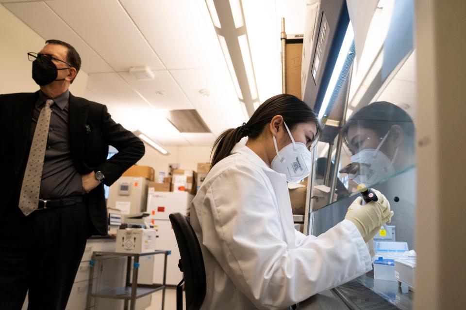 Research intern Veronica Kan screens COVID-19 testing swabs at the Hackensack Meridian Health Center for Discovery and Innovation in Nutley on Thursday, January 27, 2022. At left is David Perlin, chief scientific officer of the Center for Discovery and Innovation.