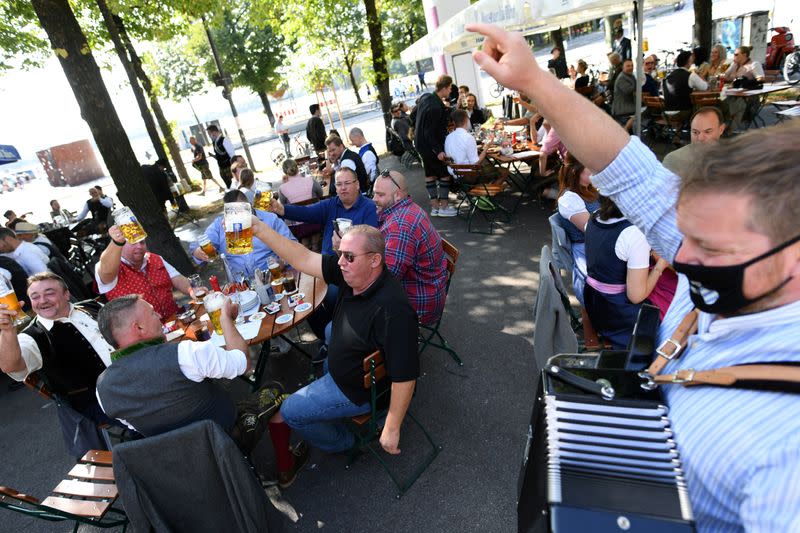 People attend a barrel tapping at a beer garden near Theresienwiese, Munich