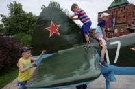 Children play on a Soviet-style military airplane at Kremlin in Nizhny Novgorod, Russia, June 30, 2018. REUTERS/Damir Sagolj