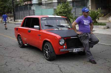 David Pena poses for a photograph with his Lada 2101 built in 1979 on a street in Havana February 9, 2015. REUTERS/Enrique De La Osa