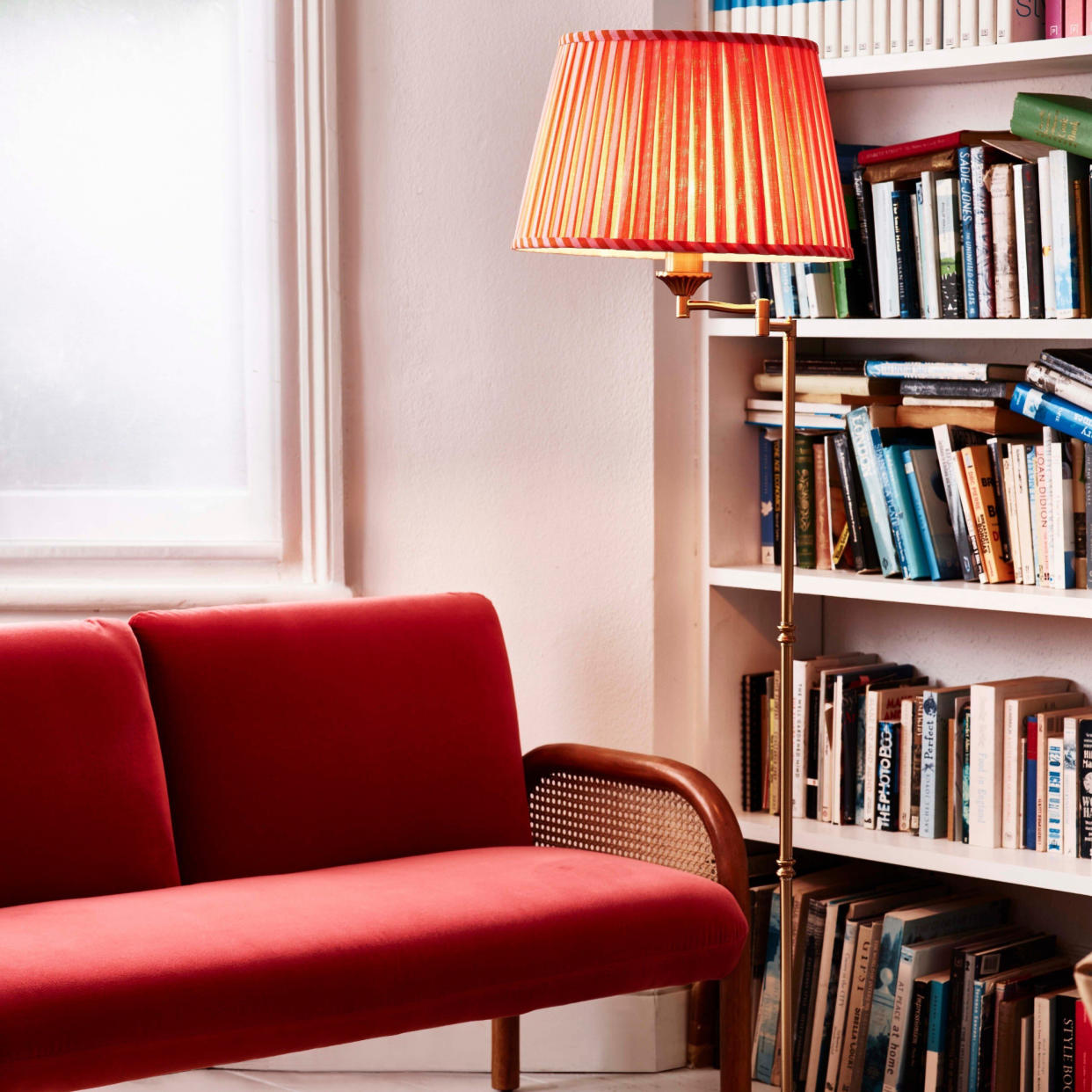  Small living room lighting idea with green sofa and black standing lamp. 