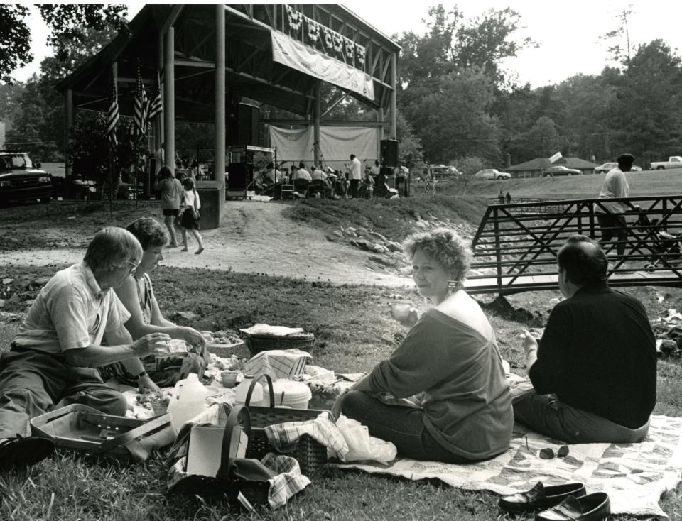 Denny and Kim Shaffer (left) and Bob and Sylvia Ray listen to the Fayetteville Symphony Orchestra concert in Rowan Park July 15, 1994. 