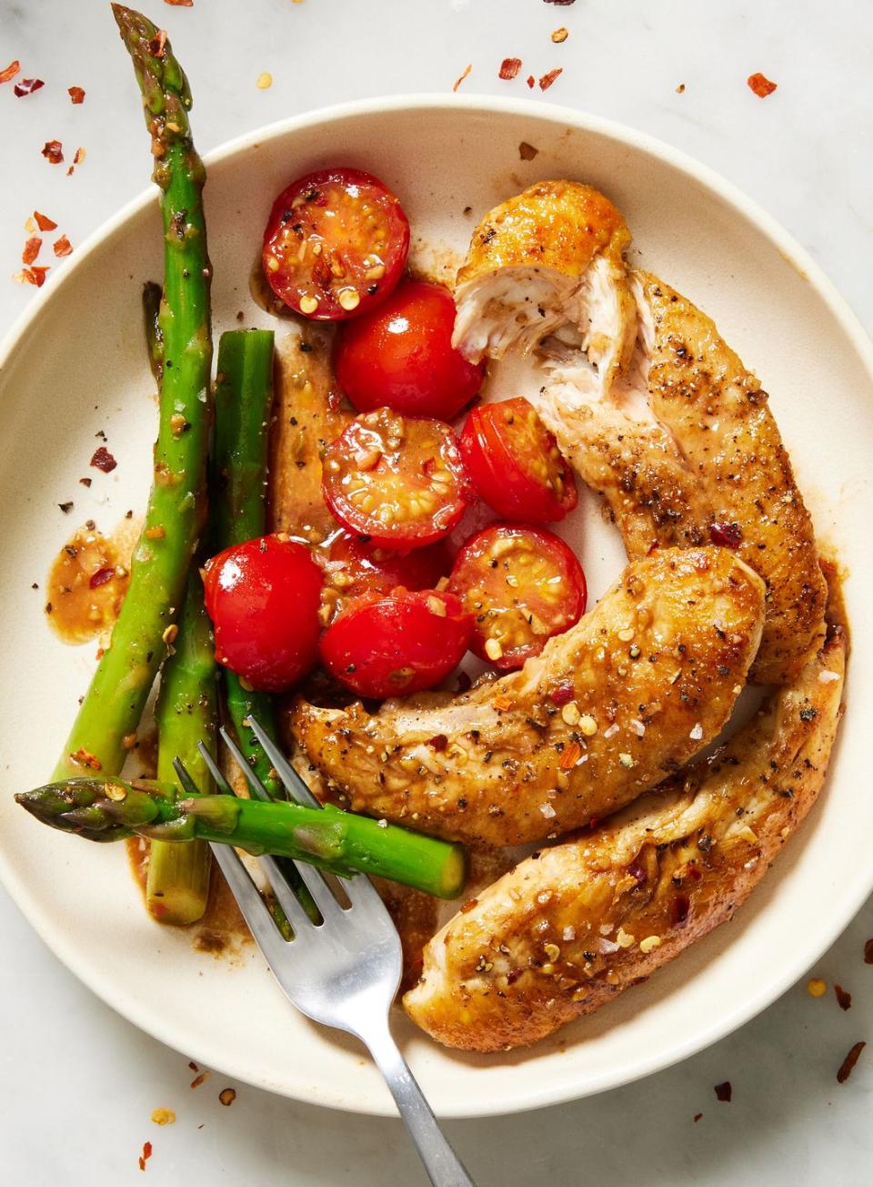 <p>We're always looking for new ways to switch up our <a href="https://www.delish.com/cooking/recipe-ideas/g2972/chicken-weeknight-dinners/" rel="nofollow noopener" target="_blank" data-ylk="slk:weeknight chicken dinner;elm:context_link;itc:0;sec:content-canvas" class="link ">weeknight chicken dinner</a>, and when we're craving something light and easy, this <a href="https://www.delish.com/cooking/menus/g1467/one-skillet-dinners/" rel="nofollow noopener" target="_blank" data-ylk="slk:one-pan;elm:context_link;itc:0;sec:content-canvas" class="link ">one-pan</a> meal is one we turn to again and again. Chicken, <a href="https://www.delish.com/cooking/g2668/spring-asparagus-dishes/" rel="nofollow noopener" target="_blank" data-ylk="slk:asparagus;elm:context_link;itc:0;sec:content-canvas" class="link ">asparagus</a> and cherry tomatoes are all cooked alongside a sharp, acidic, yet sweet homemade balsamic glaze in this recipe, so you can enjoy a dinner with maximum flavor and minimum cleanup. It's also just as versatile as it is easy: This meal is an ideal <a href="https://www.delish.com/spring-easy-weeknight-dinners/" rel="nofollow noopener" target="_blank" data-ylk="slk:spring dinner;elm:context_link;itc:0;sec:content-canvas" class="link ">spring dinner</a>, but you can switch up the veggies for whatever is in season to enjoy all year round.</p><p>Get the <strong><a href="https://www.delish.com/cooking/recipe-ideas/a54291/one-pan-balsamic-chicken-and-asparagus-recipe/" rel="nofollow noopener" target="_blank" data-ylk="slk:One-Pan Balsamic Chicken and Asparagus recipe;elm:context_link;itc:0;sec:content-canvas" class="link ">One-Pan Balsamic Chicken and Asparagus recipe</a></strong>. </p>