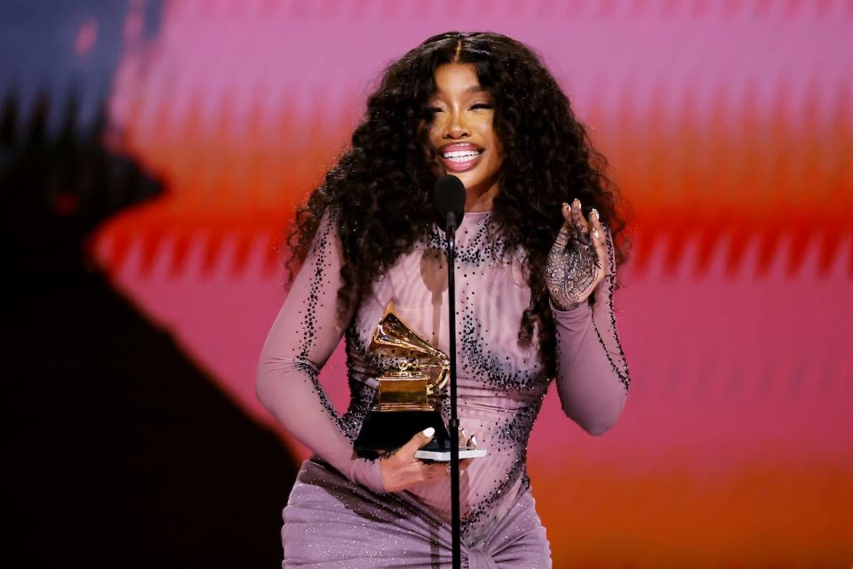 SZA gets emotional as she accepts the best R&B song award for Snooze onstage during the 2024 Grammy Awards.