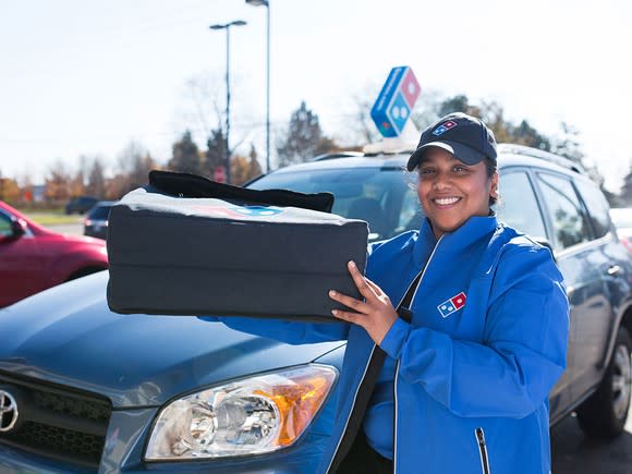 Female delivery driver holding a thermal bag