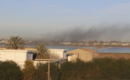 Smoke rises after an airstrike hit Maitiga airport early Thursday morning, in Tripoli March 5, 2015. REUTERS/Hani Amara