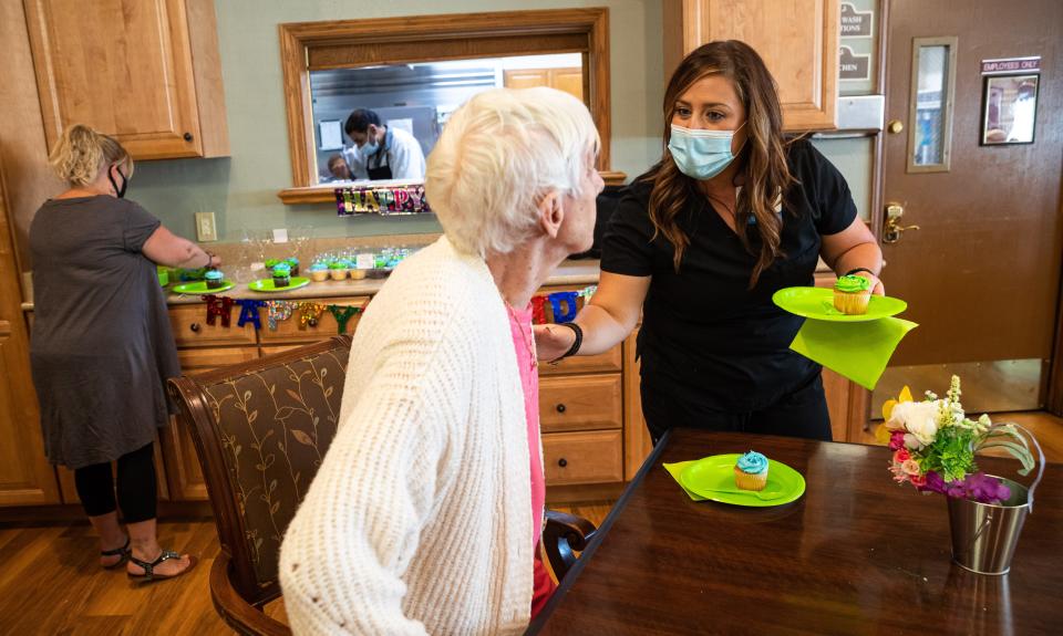 Jordan Gilboy, a home health nurse, helps a patient during a monthly birthday party held for members of an assisted living facility in Clarksville, Tenn. on Aug. 17, 2022. Gilboy recently won Tennessee's Health Care Hero 2022 award, which recognizes the health and medical professionals making an impact on the quality of health care in East Tennessee.