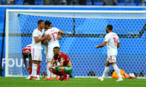 Soccer Football - World Cup - Group B - Morocco vs Iran - Saint Petersburg Stadium, Saint Petersburg, Russia - June 15, 2018 Morocco's Hakim Ziyech looks dejected as Iran's Mehdi Taremi and team mates celebrate at the end of the match REUTERS/Dylan Martinez