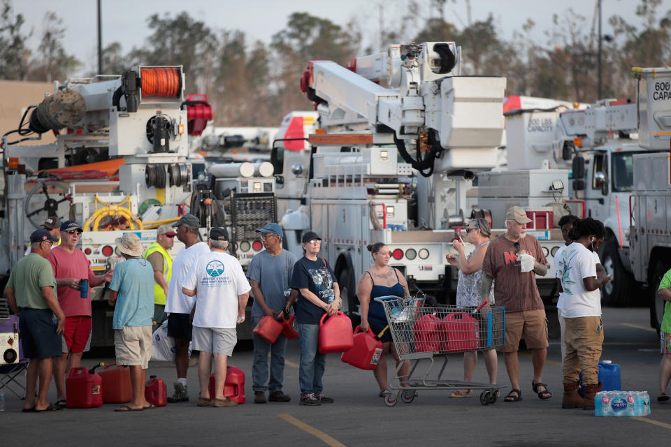 Victims of Hurricane Michael wait in line to receive a donation of up to five gallons of gas in Panama City.