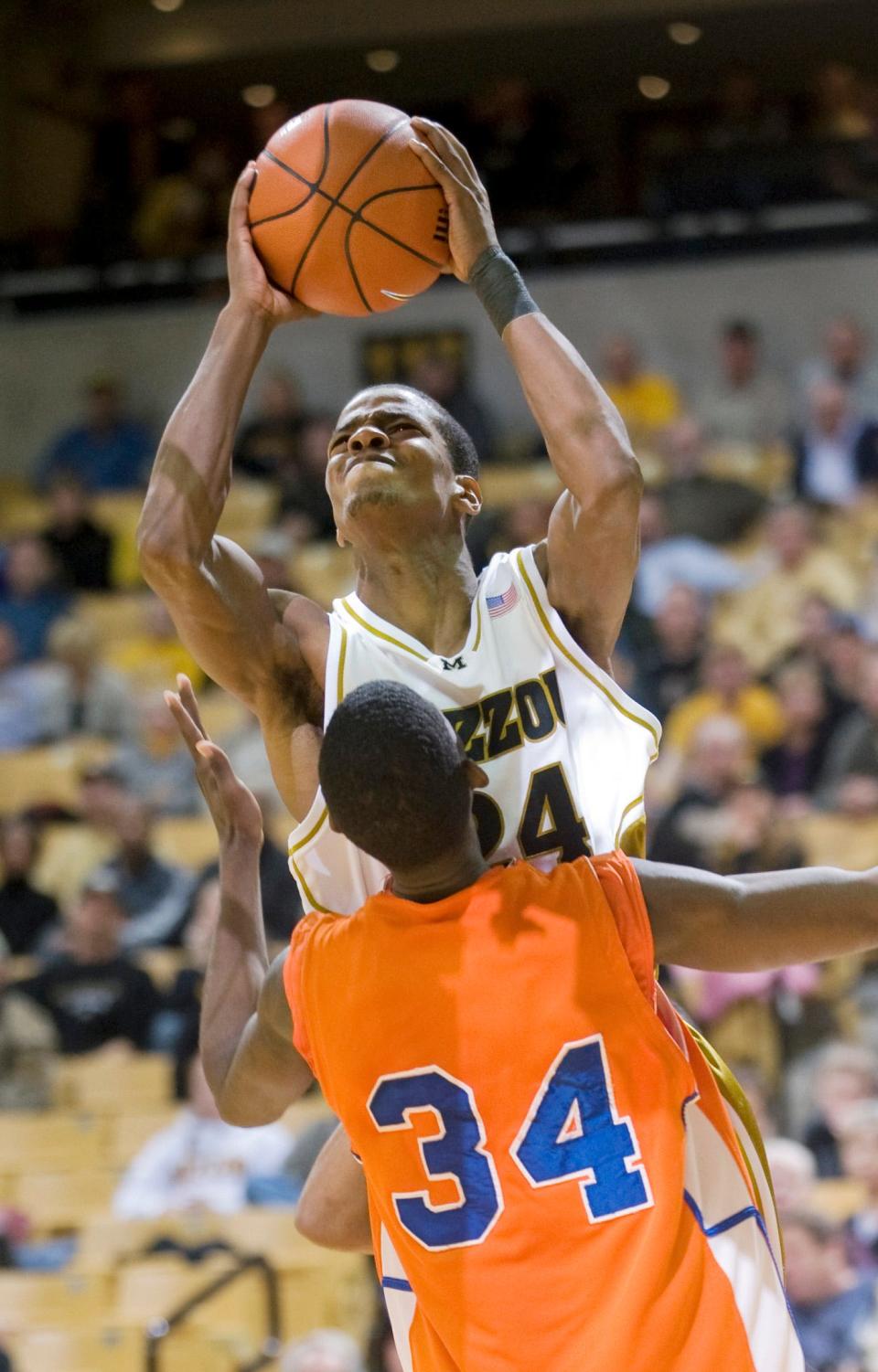 Missouri's Kim English, top, shoots over Savannah State's Arnold Louis, bottom, during a 2010 game in Columbia, Mo.