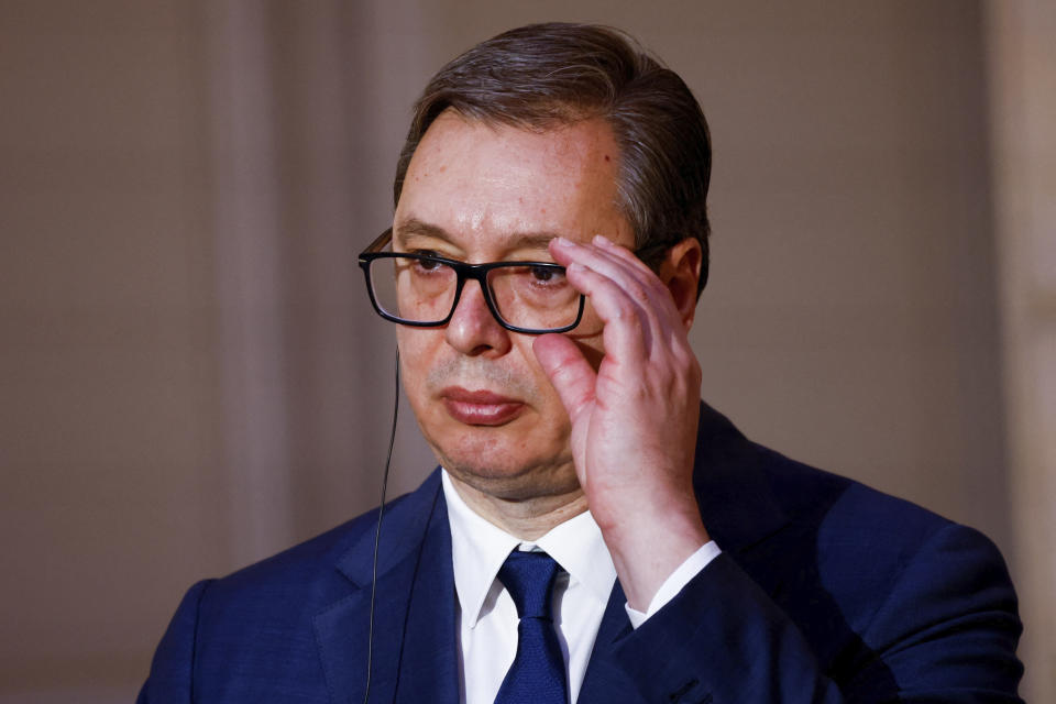 Serbian President Aleksandar Vucic adjusts his glasses during a joint statement with French President Emmanuel Macron , before a working dinner at the Elysee Palace in Paris, Monday, April 8, 2024. (Sarah Meyssonnier/Pool via AP)