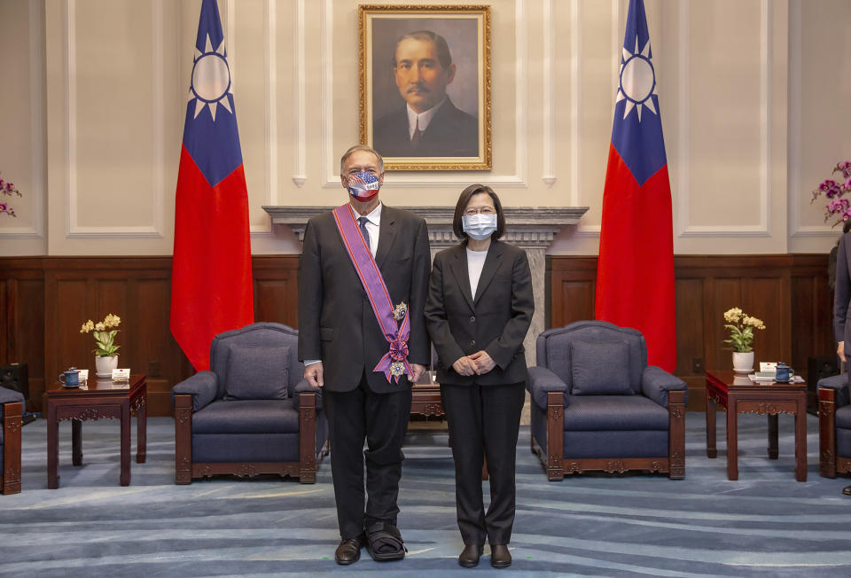In this photo released by the Taiwan Presidential Office, former U.S. Secretary of State Mike Pompeo, left, poses for a photo with Taiwan's President Tsai Ing-wen during a meeting at the Presidential Office in Taipei, Taiwan, Thursday, March 3, 2022. (Taiwan Presidential Office via AP)