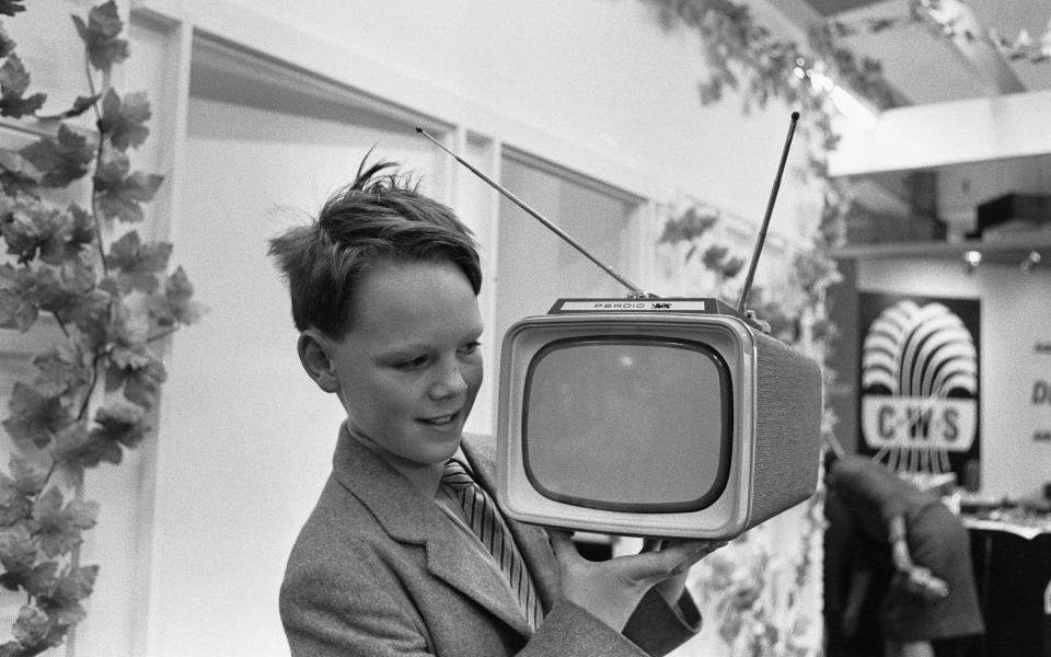 A young boy demonstrating the new Perdio Portorama portable television receiver at the National Radio Show, at Earls Court, London 22nd August 1961. (Photo by Ron Burton/Mirrorpix/Getty Images)  - Getty