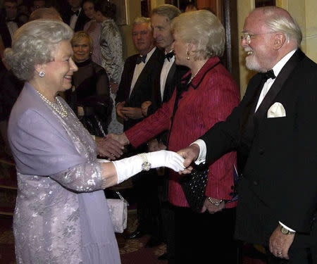 Britain's Queen Elizabeth meets Sir Richard Attenborough and his wife at a gala performance of "The Mousetrap" in London, in this 2002 file picture. REUTERS/Stringer