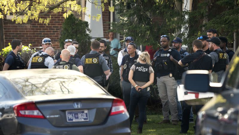 Metro Nashville Police and federal law enforcement agencies search and investigate a house in the 3000 block of Brightwood Ave. following a mass shooting at Covenant School, Monday, March 27, 2023, in Nashville, Tenn. The shooter was killed by police on the scene.