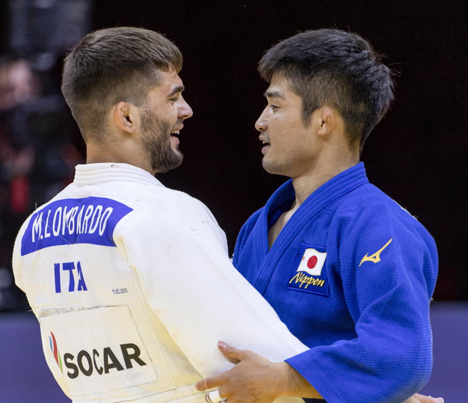 Manuel Lombardo of Italy and Joshiro Maruyama of Japan embrace after their fight in the final of men's 66kg category at the World Judo Championships in Budapest, Hungary, in this Monday, June 7, 2021, file photo. Judo is coming home at the Tokyo Olympics, and the Japanese team is under a world of pressure. Fortunately for the host nation, this powerhouse group of athletes is eager to rise to the momentousness of this moment in their sport, which was born in Japan and introduced to the Olympics at the previous Tokyo Games 57 years ago. (Zsolt Szigetvary/MTI via AP, File)