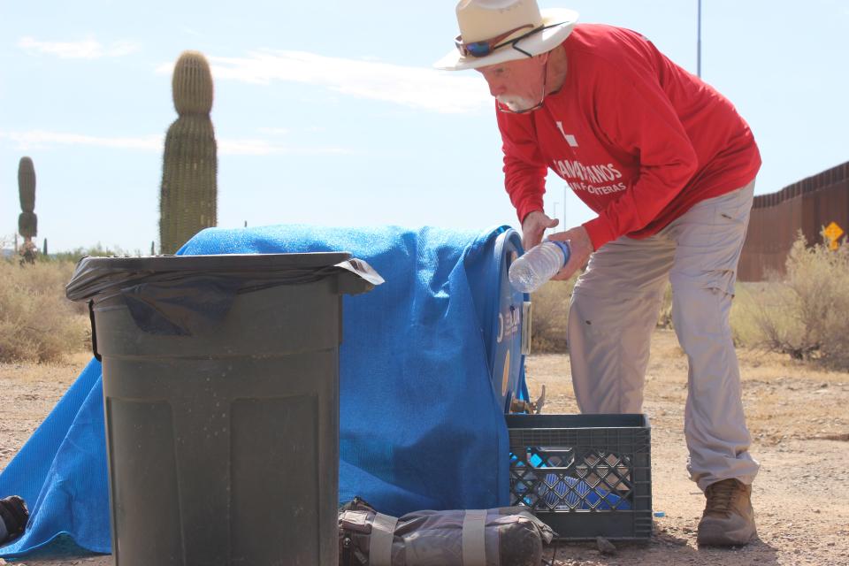 Tom Wingo, 76, refills water drums and gives water to migrants on the Organ Pipe Cactus National Monument west of Lukeville on Aug. 22, 2023.
