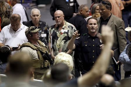 A police officer seeks witnesses to the shooting outside of the Muhammad Art Exhibit and Contest sponsored by the American Freedom Defense Initiative in Garland, Texas May 3, 2015. REUTERS/Mike Stone