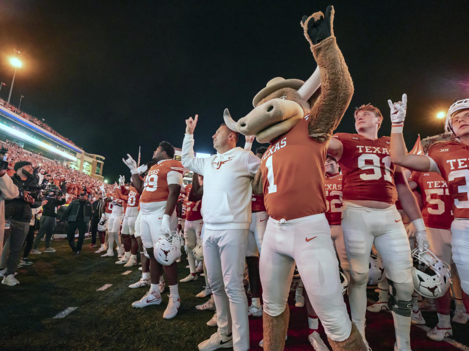 Texas coach Steve Sarkisian sings "The Eyes of Texas" with team the Bevo mascot after an NCAA college football game against Texas Tech, Friday, Nov. 24, 2023, in Austin, Texas. (AP Photo/Michael Thomas)