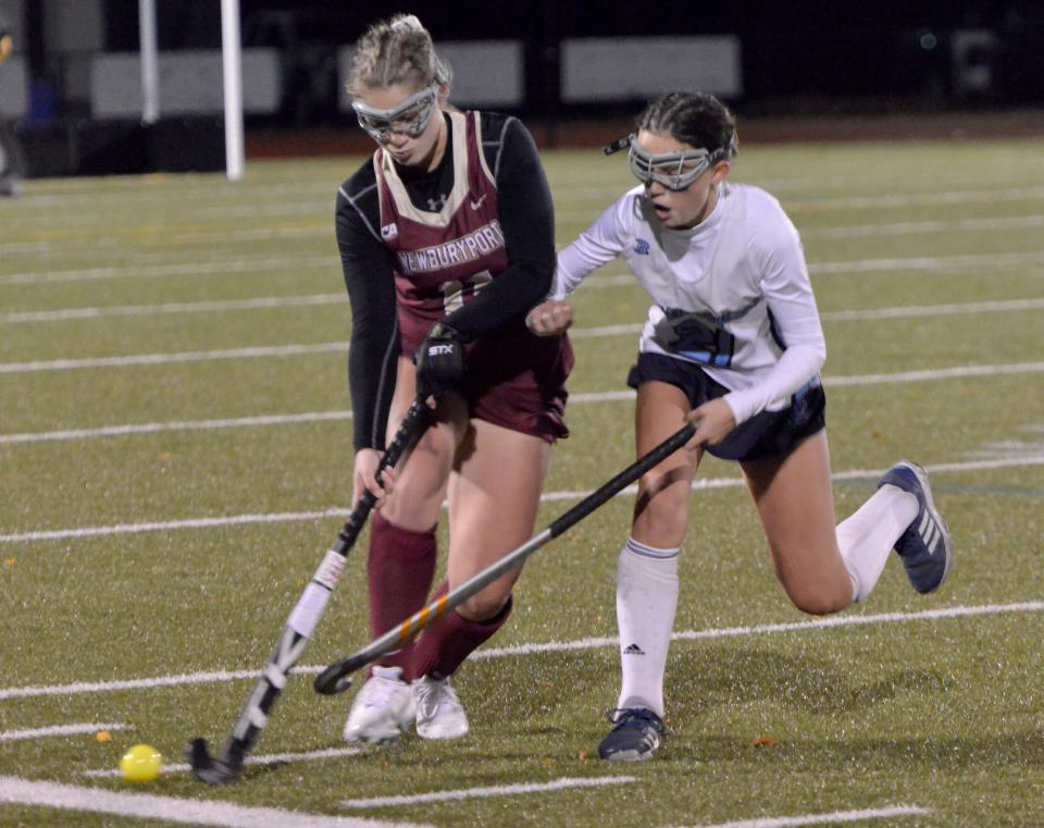 CANTON -- 11/16/22 -- Sandwich's Quinn Jordan, right, checks Newburyport's Emma Keefe as she tries to keep the ball in play during second quarter action. 
Sandwich High School played Newburyport High School in Division 3 state semifinal field hockey action Wednesday at Canton High School. Sandwich won 1-0.