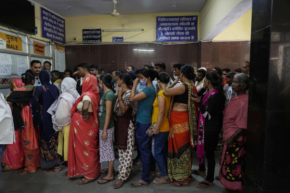 FILE - People crowd the registration counter at Tej Bahadur Sapru Hospital amid hot weather in Prayagraj, Uttar Pradesh state, India, June 23, 2022. Indian authorities need more resources and better preparation to deal with searing heat particularly for the most vulnerable communities around the country, a New Delhi-based think tank said. (AP Photo/Rajesh Kumar Singh, File)