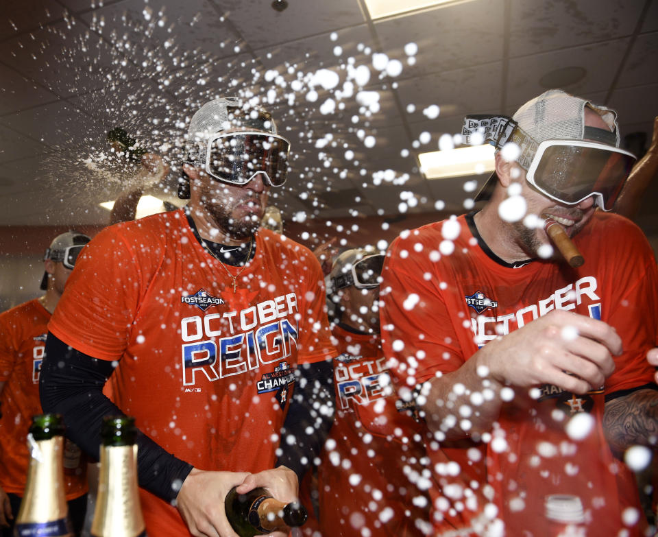 Houston Astros' George Springer, left, and Ryan Pressly celebrate their clinching of the AL West crown after a baseball game against the Los Angeles Angels, Sunday, Sept. 22, 2019, in Houston. (AP Photo/Eric Christian Smith)