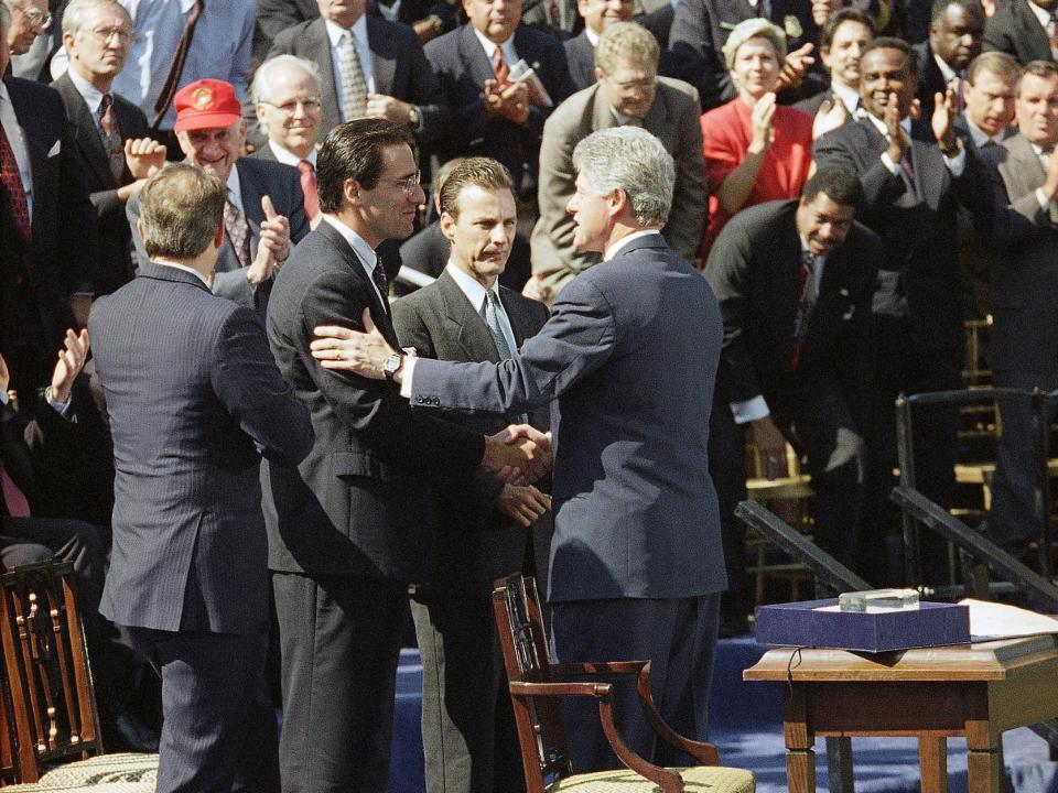 President Bill Clinton shakes hands with Stephen Sposato after he signed a sweeping crime bill that included a ban on assault weapons.