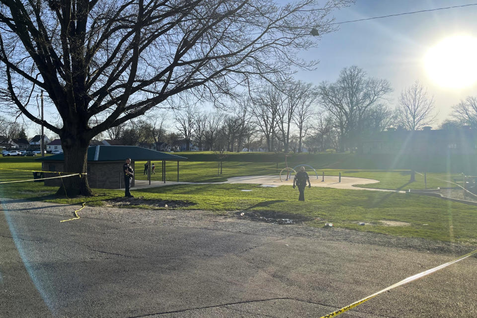 Officers guard the scene of a shooting that broke out during a memorial at McCormick Park on Wednesday, April 12, 2023, in Fort Wayne, Ind. Multiple people were wounded Wednesday in a shooting at an Indiana park during a memorial, police said.(Corryn Brock/The Journal-Gazette via AP)