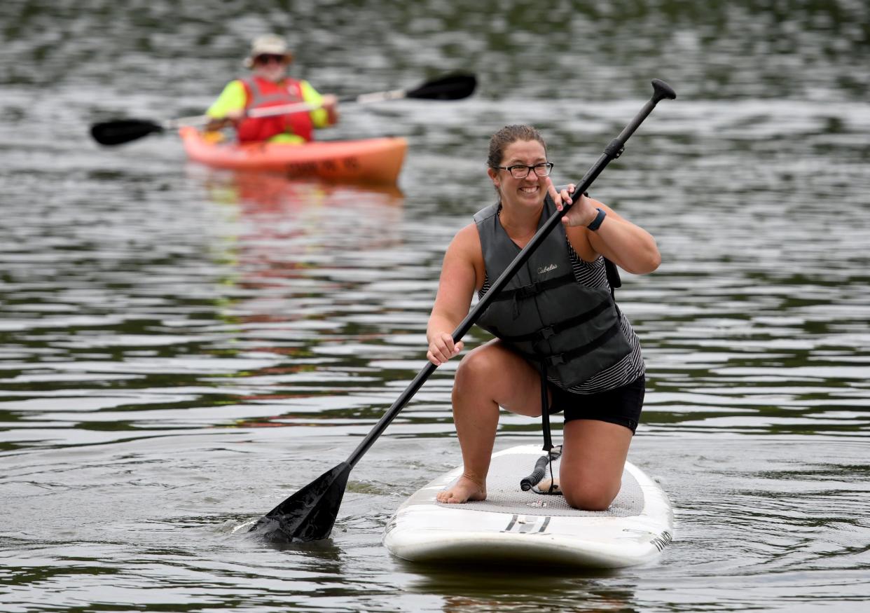 Amber Nesbitt of Perry Township gets a chance to try out a paddleboard during the recent Summerfest at Sippo Lake Park in Perry Township.