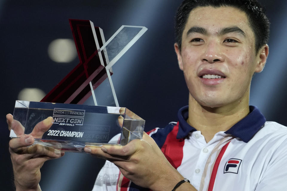 FILE - Brandon Nakashima holds the trophy during ceremonies after defeating Czech Republic's Jiri Lehecka in the final of the ATP Next Gen tennis tournament in Milan, Italy, Nov. 12, 2022. No American man has won a Grand Slam singles title since 2003. There is a crop of players from the U.S. hoping to end that drought at some point. Nakashima is a 21-year-old from California. He could face Rafael Nadal in the second round of the Australian Open. (AP Photo/Luca Bruno, File)