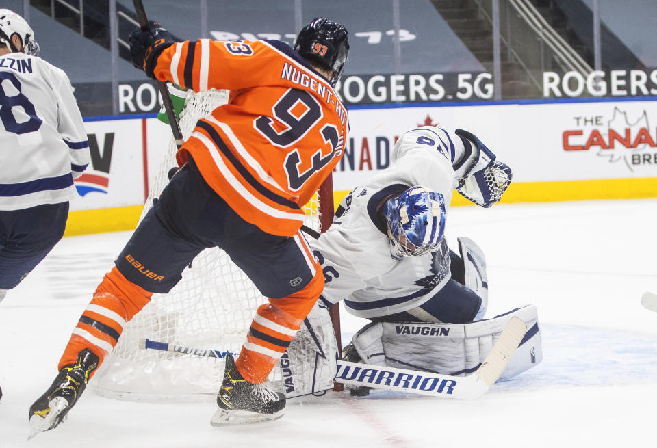 Edmonton Oilers' Ryan Nugent-Hopkins (93) is stopped by Toronto Maple Leafs goalie Jack Campbell (36) during the second period of an NHL game in Edmonton, Alberta, on Saturday, Feb. 27, 2021. (Jason Franson/The Canadian Press via AP)