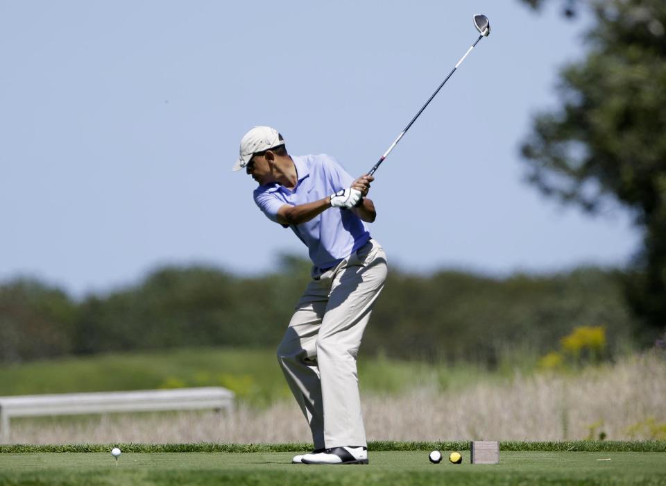 President Barack Obama tees off while golfing at Vineyard Golf Club in Edgartown, Mass., on the island of Martha's Vineyard Wednesday, Aug. 14, 2013. (AP Photo/Steven Senne)