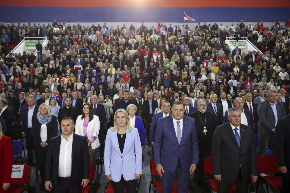 Serb member of the Bosnian Presidency Milorad Dodik, center right, who is running for the President of Republika Srpska and Zeljka Cvijanovic, center left, who is running for the Bosnian Presidency listen to the party anthem at the Alliance of Independent Social Democrats (SNSD) campaign rally in Istocno Sarajevo, Bosnia, Tuesday, Sept. 27, 2022. Bosnia's upcoming general election could be about the fight against corruption and helping its ailing economy. But at the time when Russia has a strong incentive to reignite conflict in the small Balkan nation, the Oct 2. vote appears set to be an easy test for long-entrenched nationalists who have enriched cronies and ignored the needs of the people. (AP Photo/Armin Durgut)