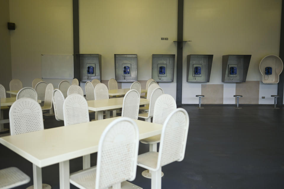 A seated area with telephones on the wall inside the centre. Source: AAP, file.