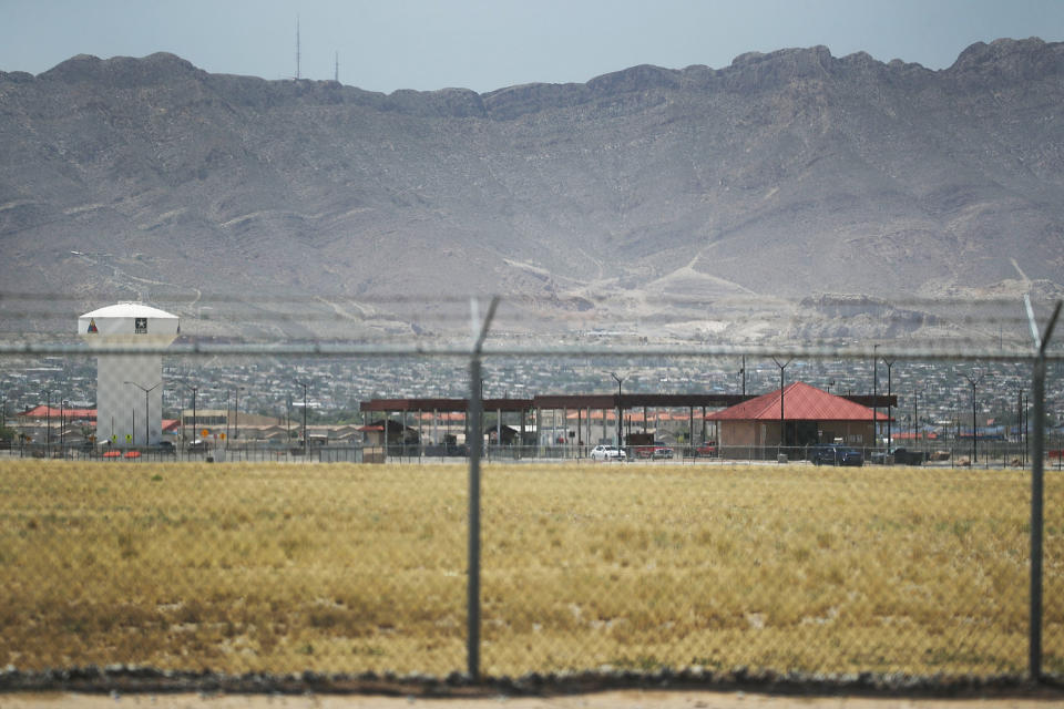 Fort Bliss, which holds temporary housing for migrants, is seen through a fence. (Joe Raedle / Getty Images file)