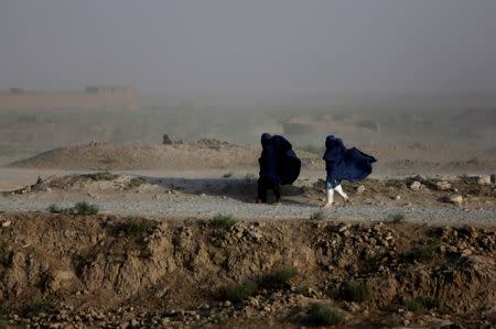 Women walk on a windy day outside Kabul, Afghanistan, July 23, 2013. REUTERS/Mohammad Ismail/File Photo