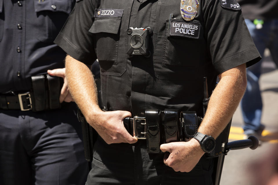 Los Angeles, California / USA - May 1, 2020: A Los Angeles Police (LAPD) Officer wearing a body camera stands watch outside of City Hall.