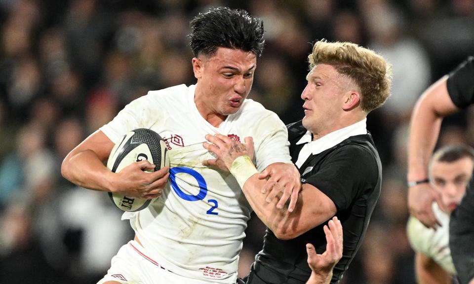 <span>England fly-half Marcus Smith rides the tackle of his opposite man Damian McKenzie in Dunedin.</span><span>Photograph: Joe Allison/The RFU Collection/Getty Images</span>