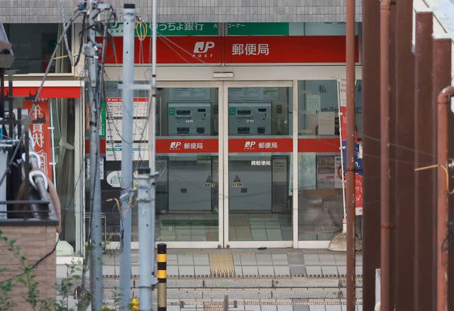 <p>STR/JIJI Press/AFP via Getty</p> The area around a post office in Japan