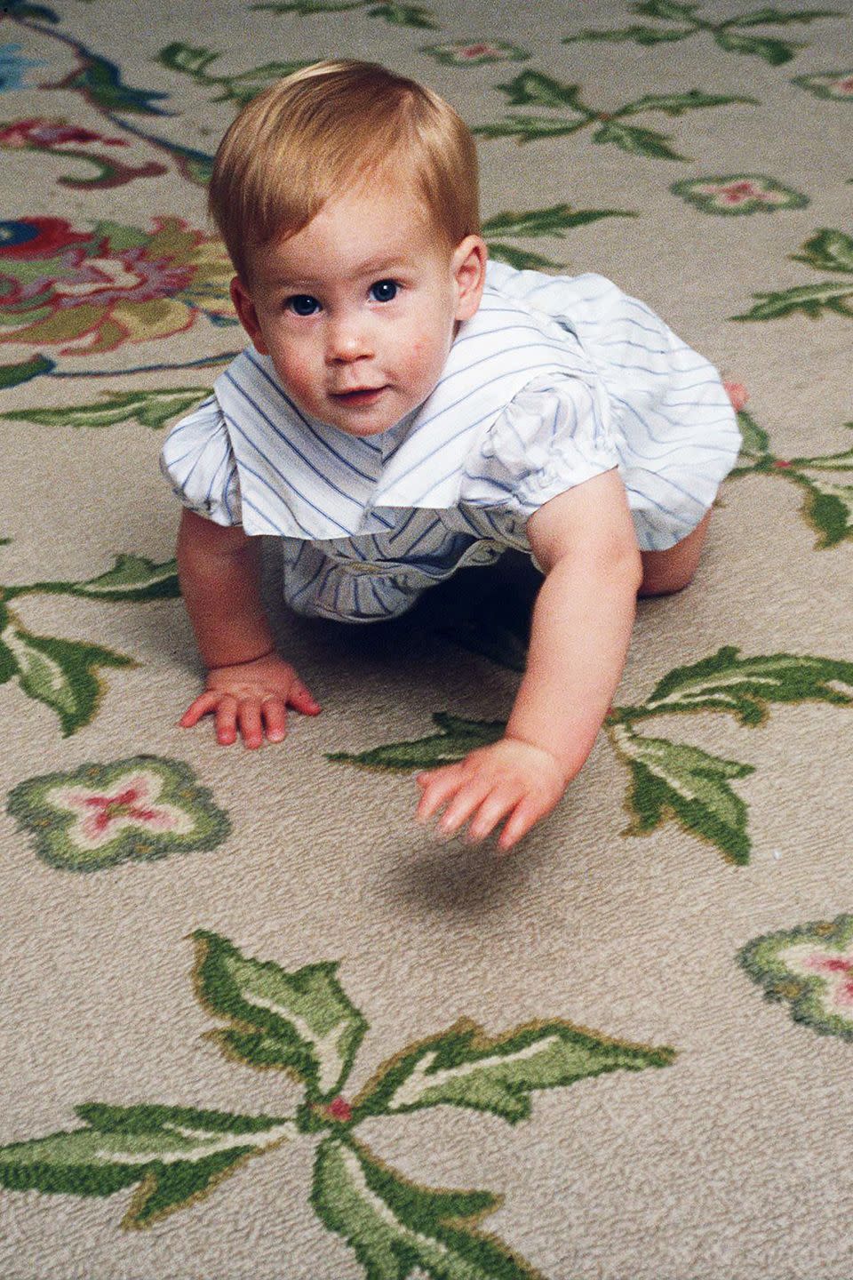 <p>Prince Harry learns to crawl in Kensington Palace.</p>