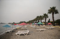 The Oren beach near the Kemerkoy Power Plant, a coal-fueled power plant, in Milas, Mugla in southwest Turkey, Thursday, Aug. 5, 2021. A wildfire that reached the compound of a coal-fueled power plant in southwest Turkey and forced evacuations by boats and cars, was contained on Thursday after raging for some 11 hours, officials and media reports said. (AP Photo/Emre Tazegul)