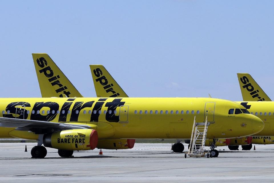 A line of Spirit Airlines jets sit on the tarmac at Orlando International Airport on May 20, 2020, in Orlando. Jet Blue and Spirit announced a merger creating the fifth largest airline in the US.